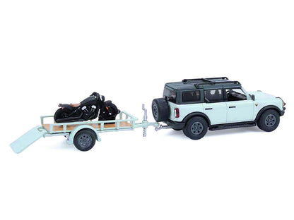 GreenLight 2021 Ford Bronco 4-Door Badlands Cactus Gray with Black Top and Motorcycle Utility Trailer "Hitch & Tow" Series 33 1/64 Diecast Model Cars by <h2>2021 Greenlight</h2> <p>High-quality car pe