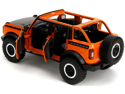 2021 Ford Bronco Open-Top Orange with Black Stripes and Hood Extra Wheels "Just Trucks" Series 1/24 Diecast Model Car by Jada <h2>2021 Jada</h2> <p>High-quality perfect for collectors enthusiasts. Fea