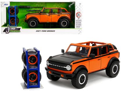 2021 Ford Bronco Open-Top Orange with Black Stripes and Hood Extra Wheels "Just Trucks" Series 1/24 Diecast Model Car by Jada <h2>2021 Jada</h2> <p>High-quality perfect for collectors enthusiasts. Fea