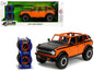 2021 Ford Bronco Open-Top Orange with Black Stripes and Hood Extra Wheels "Just Trucks" Series 1/24 Diecast Model Car by Jada <h2>2021 Jada</h2> <p>High-quality perfect for collectors enthusiasts. Fea