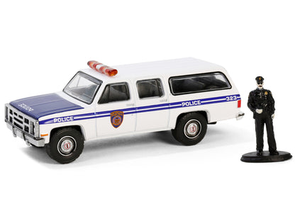 GreenLight 1985 GMC Suburban 2500 "New York City Transit Police Department" White with Blue Stripes and Officer Figure "The Hobby Shop" Series 16 1/64 Diecast Model Car by <h2>1985 Greenlight</h2> <p>