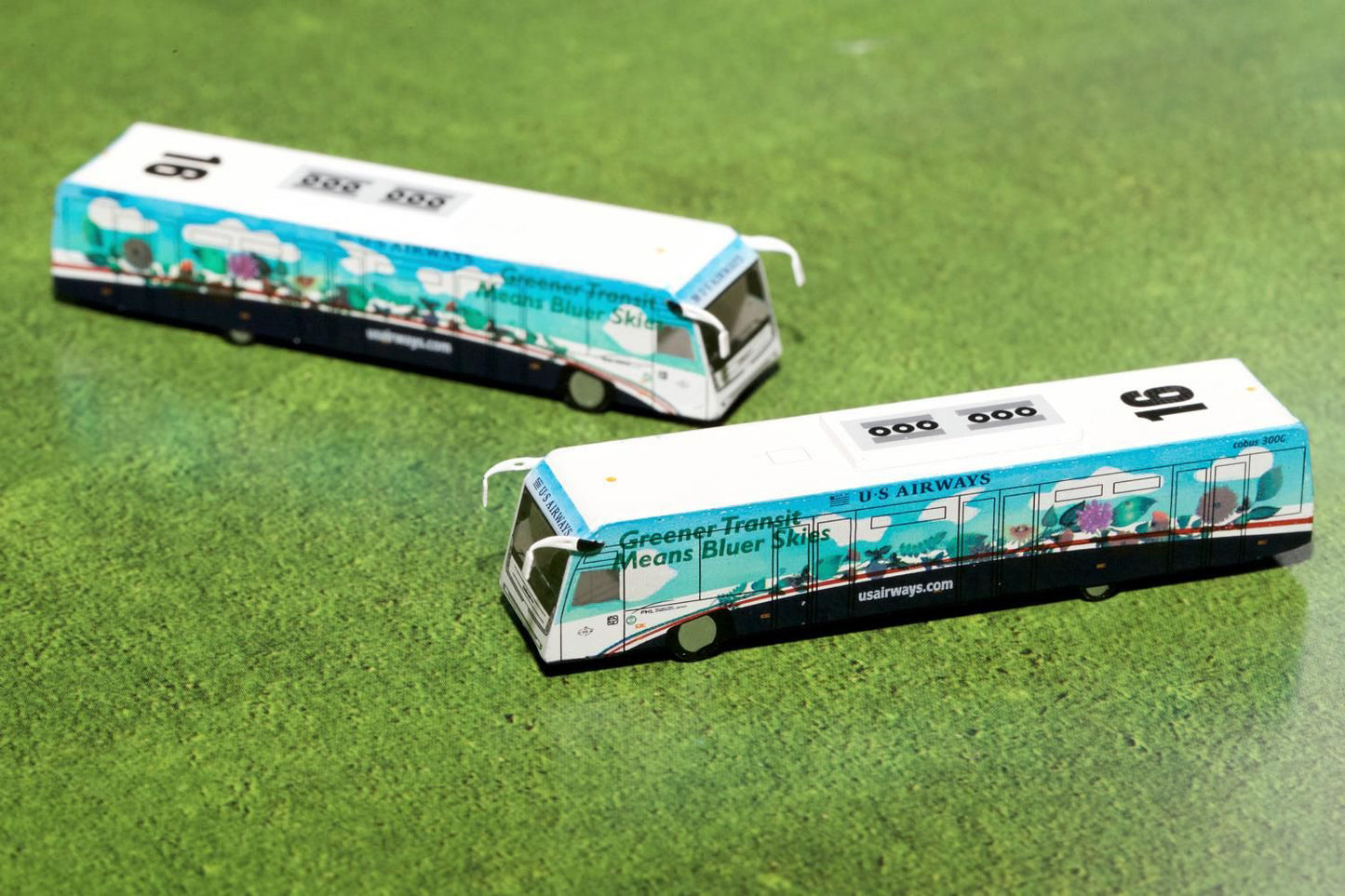 Cobus 3000 Passenger Bus White and Blue with Graphics "US Airways Shuttle - Greener Transit" 2 Piece Set "Gemini 200" Series Diecast Models by GeminiJets <h2>Cobus GeminiJets</h2> <p>High-quality mode